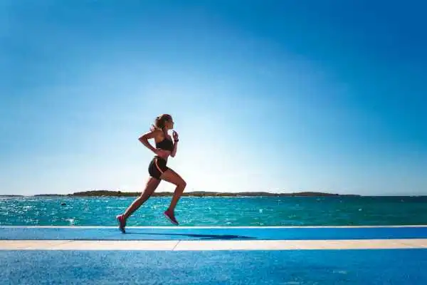 Woman running showing strong leg muscle Huntingdon